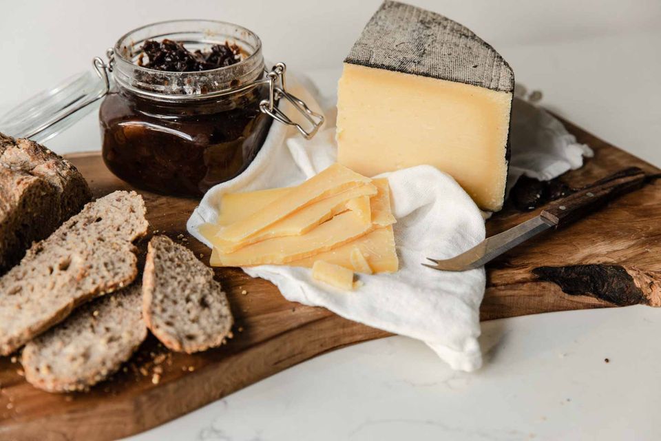 Cornish yarg on a cheeseboard with Cornish produce