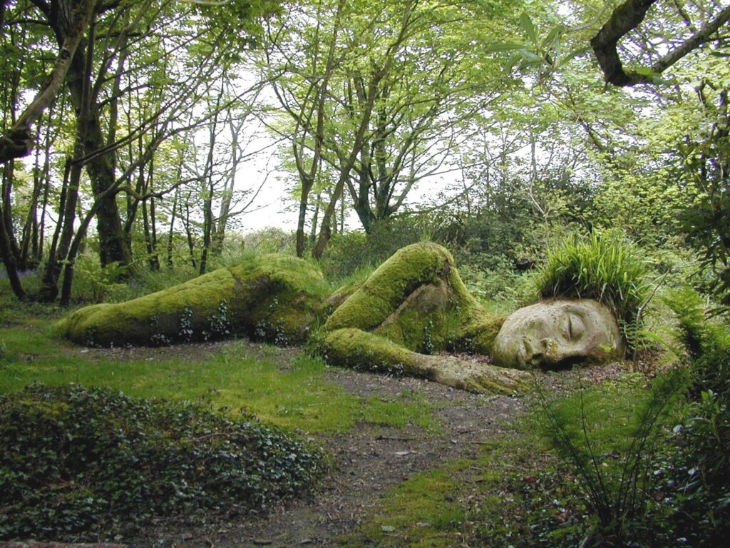 sleeping lady made from stone, moss and grass at the lost gardens of heligan